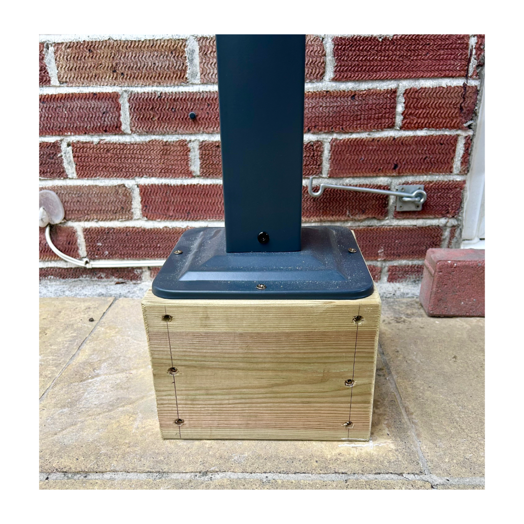a wooden foot with a metal leg from a gazebo on top.