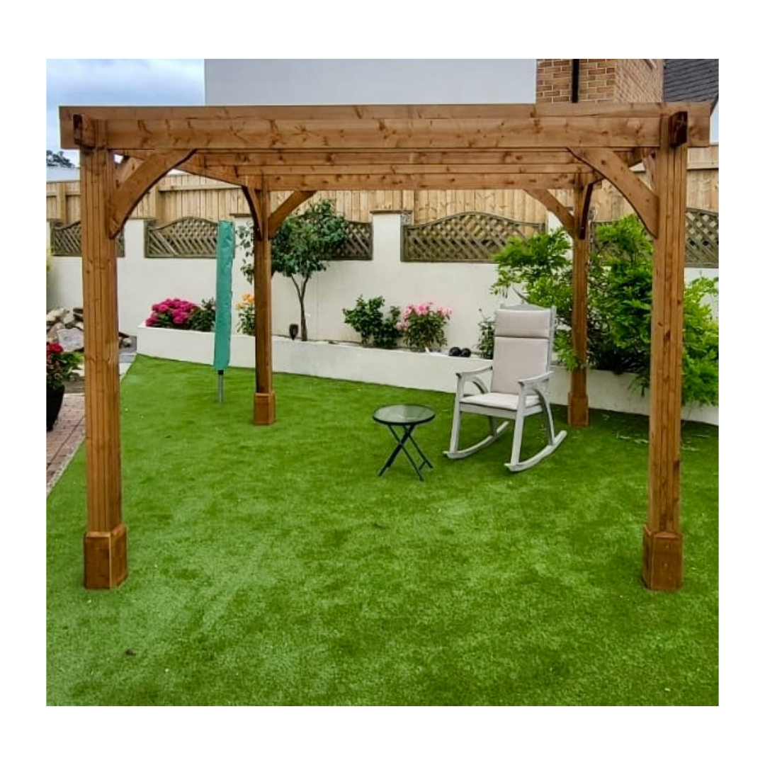 Wooden pagoda in a garden on grass with a rocking chair and a small table.